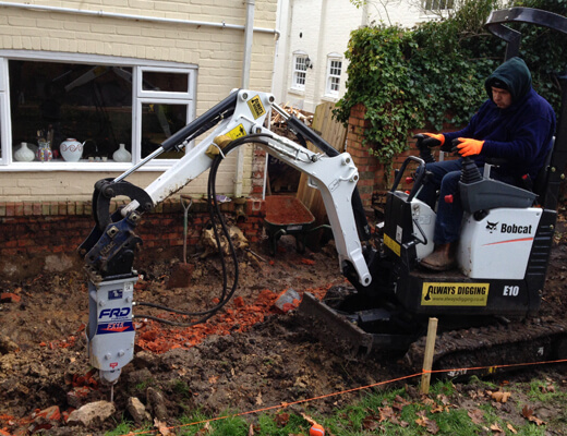 Furukawa F15 hydraulic breaker on a Bobcat mini digger breaking out foundations in a garden