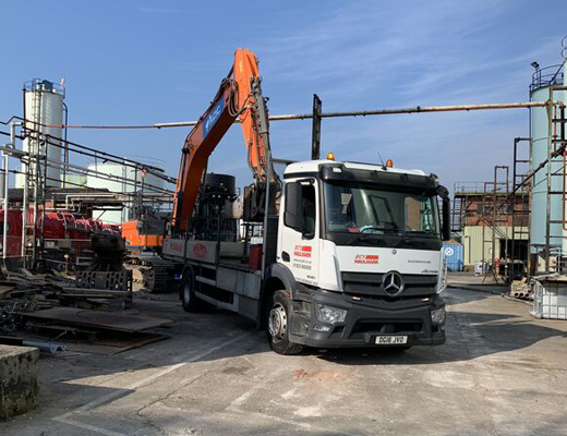 Hydraulic breaker being delivered to a demolition site on an ECY Haulmark wagon